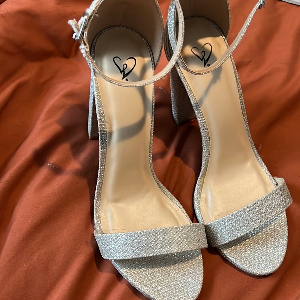 Windsor heels never worn. Pup chewed up the ankle wrap a bit but still latches